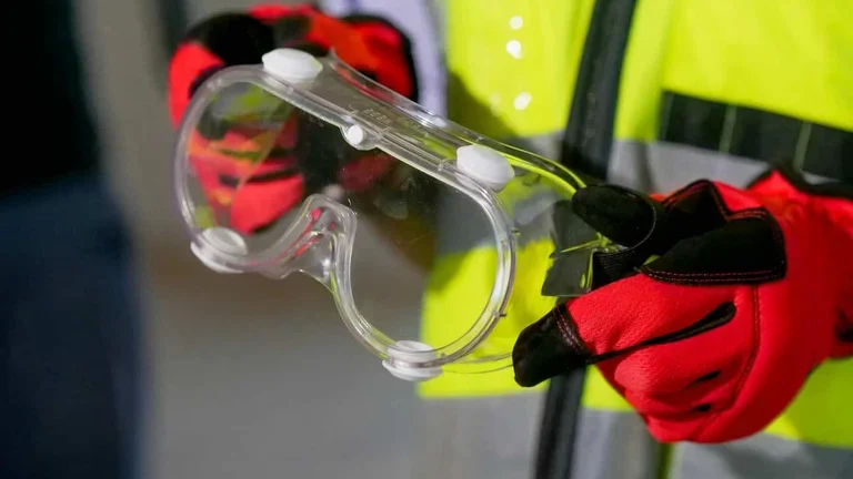 person holding safety glasses for a blog about what are the safety data sheets