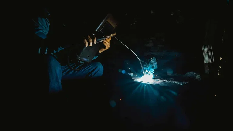 photo of a person doing welding work, for a blog about shielding gas